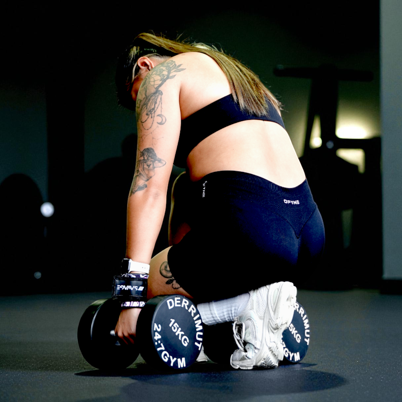 Person lifting weights in a gym setting