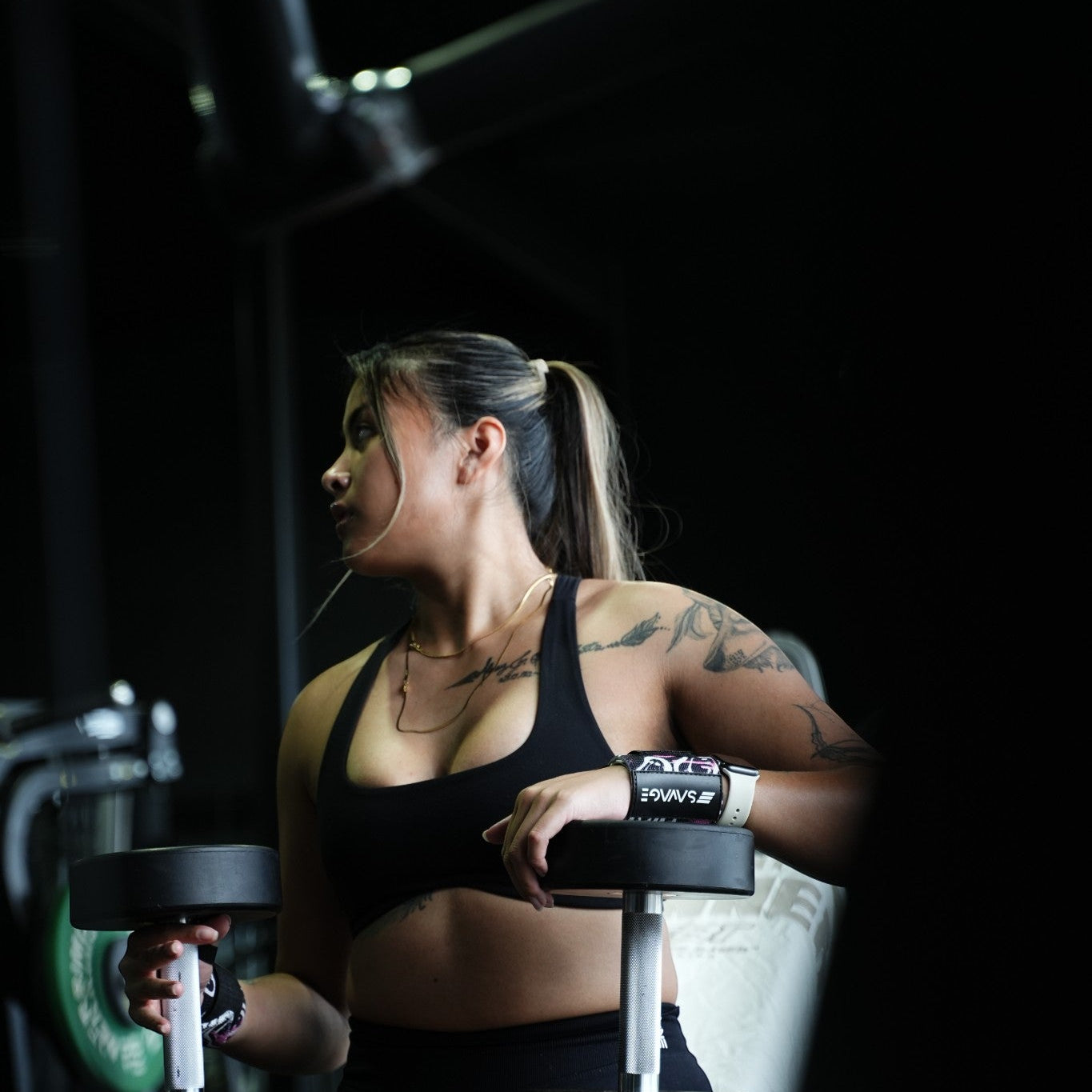 Woman exercising with dumbbells in a gym setting