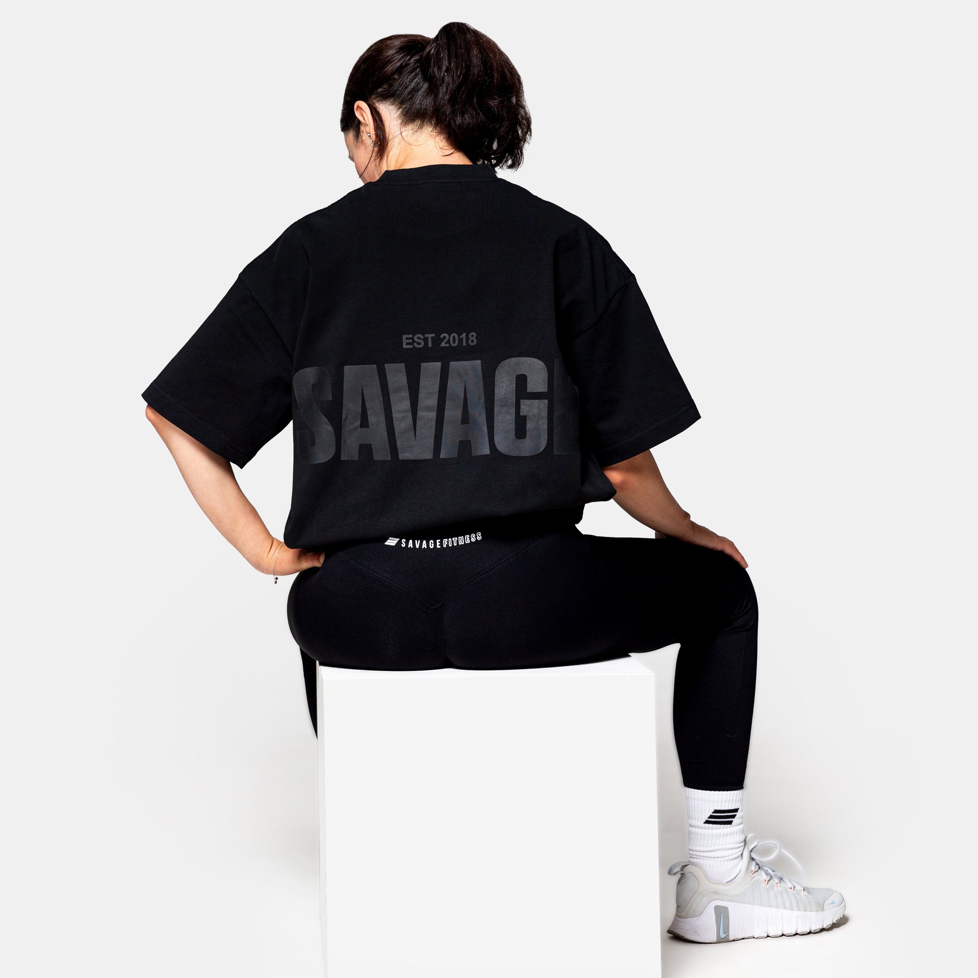 Savage Fitness oversized black tee womens back view with large SAVAGE print